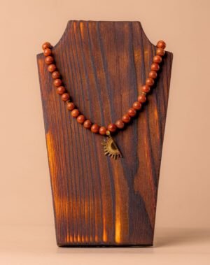 Collier en sable d'or avec pendentif soleil